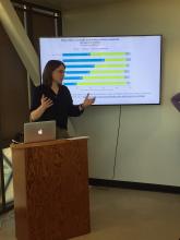 a woman gives a presentation by a graph