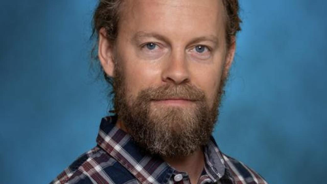 A Headshot of a man with facial hair.
