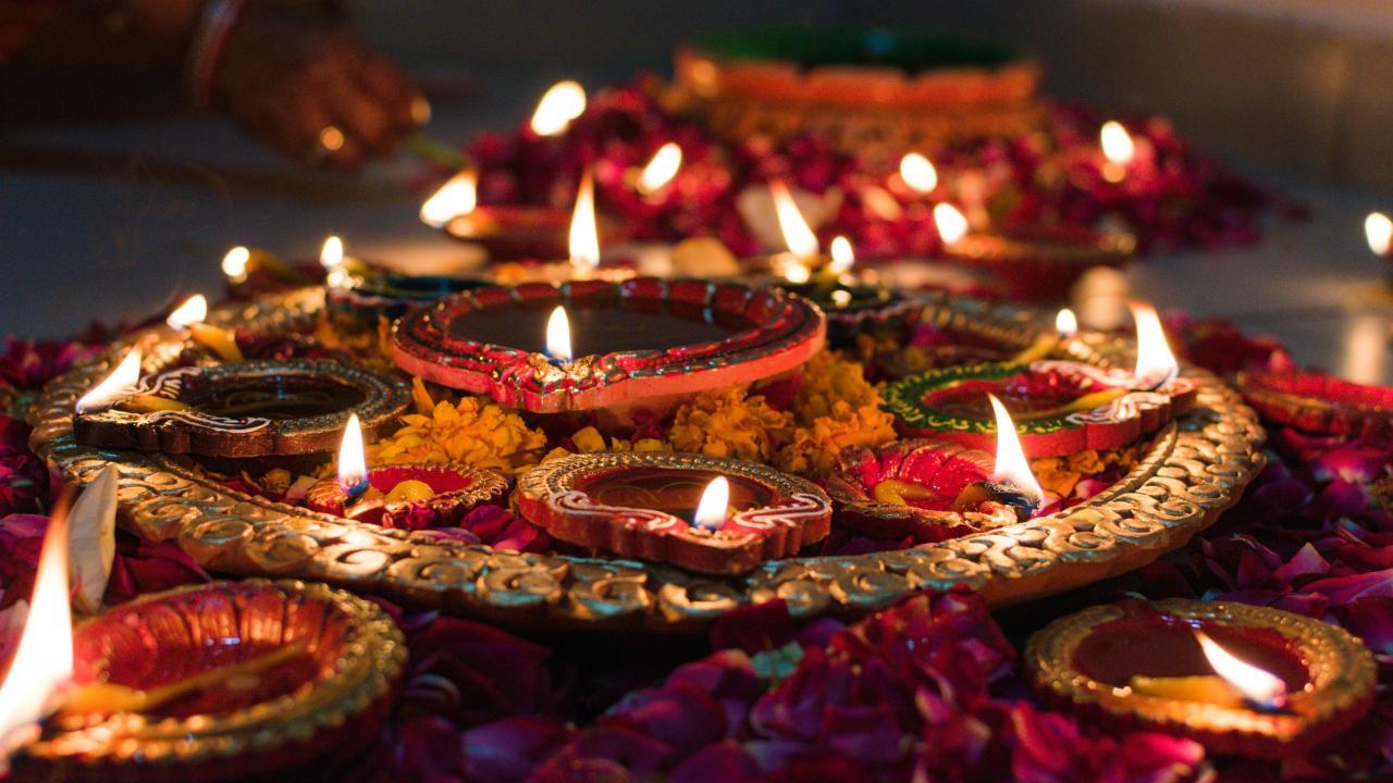 Many colorful lit ceremonial candles and flowers.