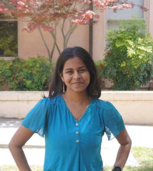 A woman in a blue top with long hair