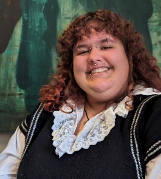 A woman with curly hair smiling