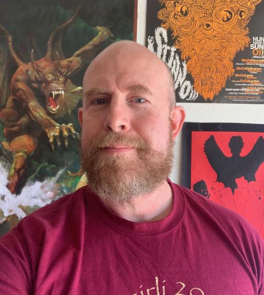 picture of smiling bald man with red beard