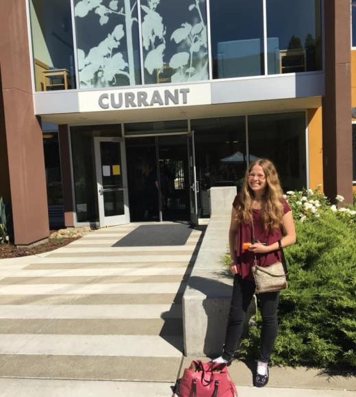 Emma stands outside Currant Hall in the Tercero residence hall area.