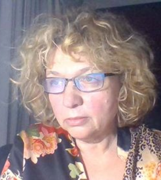 Woman in glasses looking out the window