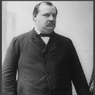 A black and white photo of Grover Cleveland, wearing a bowtie
