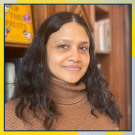 A woman with long black hair looking at the camera