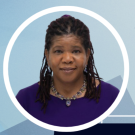 A headshot of Stephanie Milton with a blue background