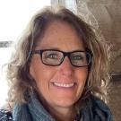 A portrait of a woman wearing glasses.
