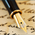 A pen laying atop a paper with cursive script